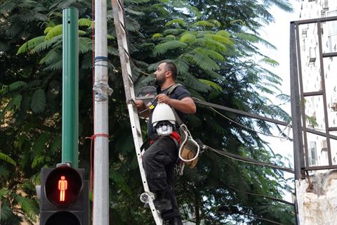 File - A worker attaches a surveillance camera in Hamra's Piccadilly street as part of a government funded project in the Greater Beirut area, Friday, Sept. 20, 2013. (The Daily Star/Mohammad Azakir)