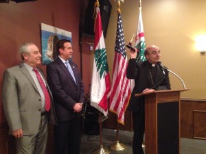 Lebanese Forces USA Coordinator Maurice Daaboul and Detroit Chapter President Tony Malouf present Bishop A. Elias Zaidan with an honorary plaque.
