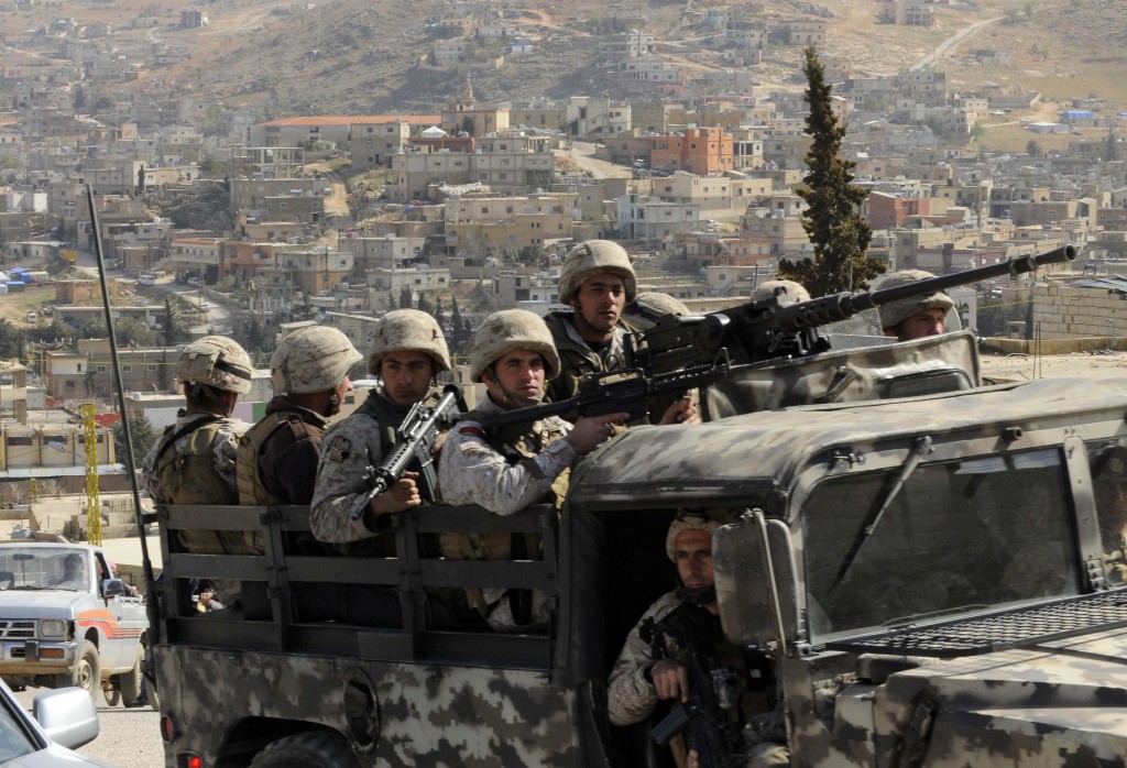 Lebanese army soldiers patrol on their armoured vehicle the Sunni Muslim border town of Arsal