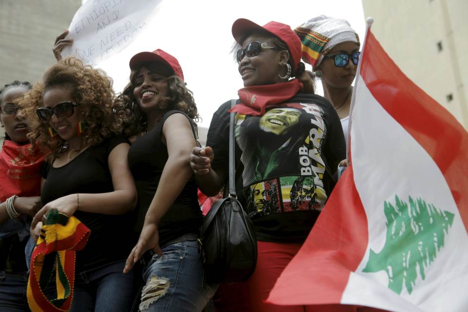 Migrant domestic workers dance with a Lebanese flag during a parade in Beirut, to support the rights of migrant domestic workers in Lebanon and calling for a domestic workers union in Beirut May 3, 2015. REUTERS/Alia Haju