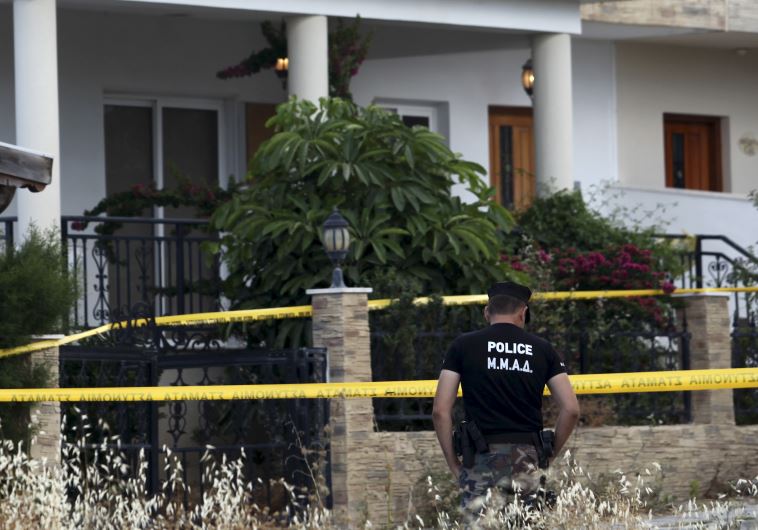 A policeman stands guard at a house where police discovered almost two tonnes of ammonium nitrate, in Larnaca, Cyprus, May 29, 2015. (Reuters)