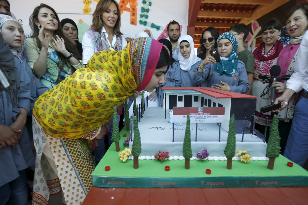 Nobel Peace Prize laureate Malala Yousafzai (C) blows out the candles on her birthday cake at a new school for Syrian refugee girls in Lebanon’s Bekaa Valley, July 12, 2015. Yousafzai celebrated her 18th birthday in Lebanon on Sunday by opening the school and called on world leaders to invest in “books not bullets”. (Jamal Saidi/Reuters)