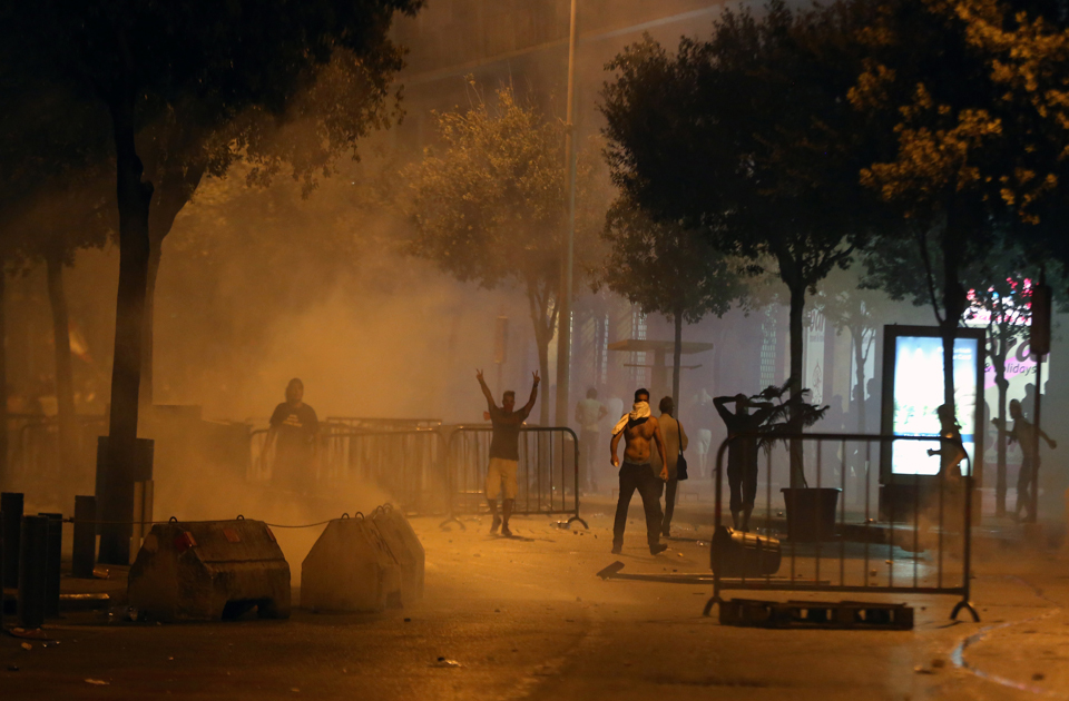 Lebanese protesters clash near government buildings with security forces who donned riot gear and used tear gas, water cannons, and gunfire to disperse the crowds over the country's trash crisis. (Photo via ahram.org.eg)