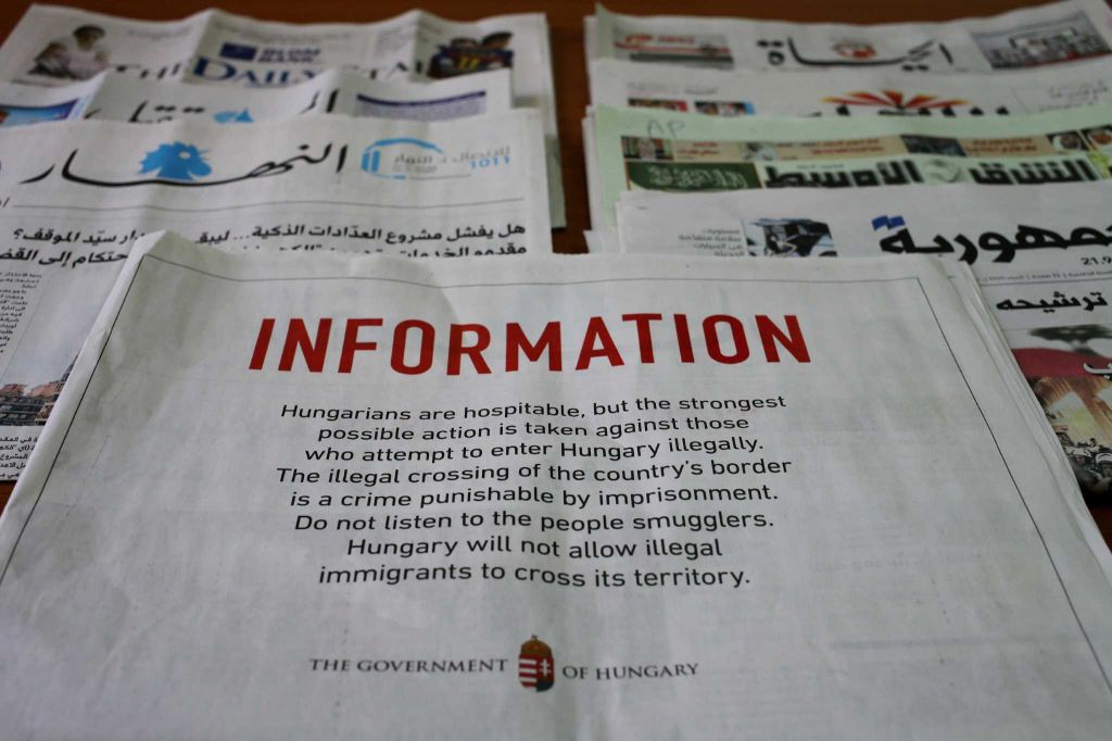 A full-page advertisement by the Hungarian government that was published in Lebanese newspapers, warning migrants not to enter the country illegally saying it is a crime punishable by imprisonment, in Beirut, Lebanon, Monday, Sept. 21, 2015. Hungary, which closed its border with Serbia on Sept. 15, erected another steel barrier at the Beremend border crossing from Croatia to try to slow the flow of migrants. But they kept coming. Lebanon has nearly 1.2 million Syrian refugees some of whom have expressed interest in migrating to Europe because of poor conditions they live in here. (AP Photo/Hussein Malla)