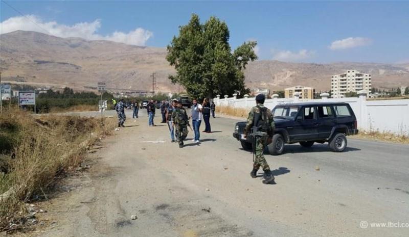 Security officials block off a roadway in Chtaura, Lebanon, after a roadside bomb went off targeting a passenger van transporting travelers to Syria on October 5, 2015. (Photo via LBCI)