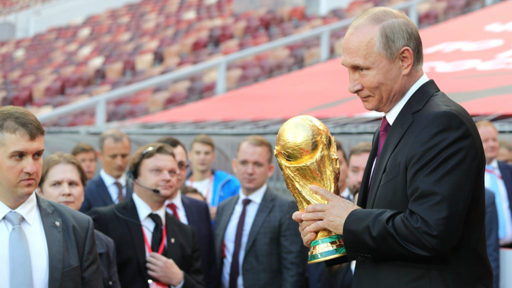 Russian president Vladimir Putin holding the FIFA World Cup Trophy at a pre-tournament ceremony in Moscow, September 2017. (Administration of the President of Russia)