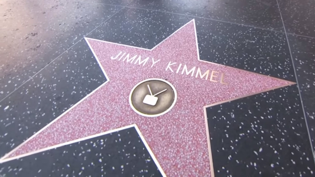 The fan was taking a picture of Jimmy Kimmel's Hollywood star when he approached her. (YouTube screen grab)